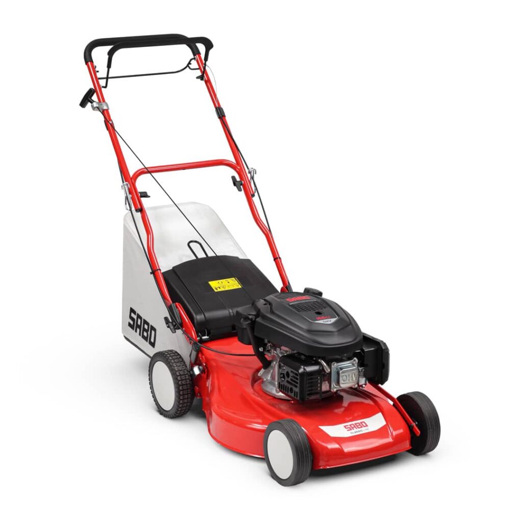 SABO Classic petrol lawn mower with red metal deck, black OHV engine, large grass collection bag, and red tubular handle, photographed on a white background.